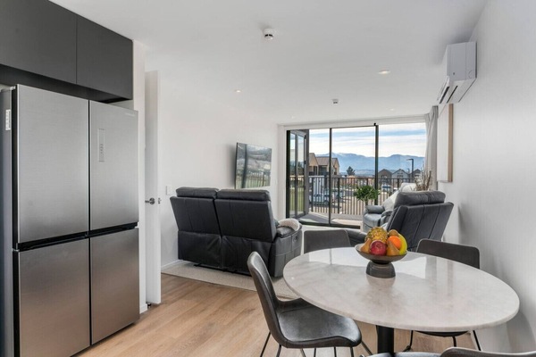 open plan living area with dining table to seat 4