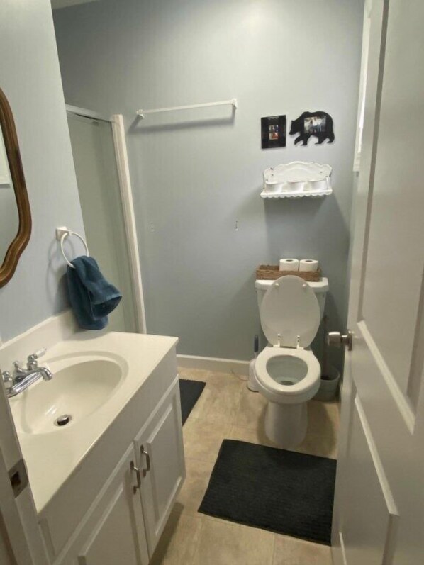 A bathroom with a white sink, toilet, and a towel rack. - 442 Cedar Ave. in Lakeside (Lakeside)
