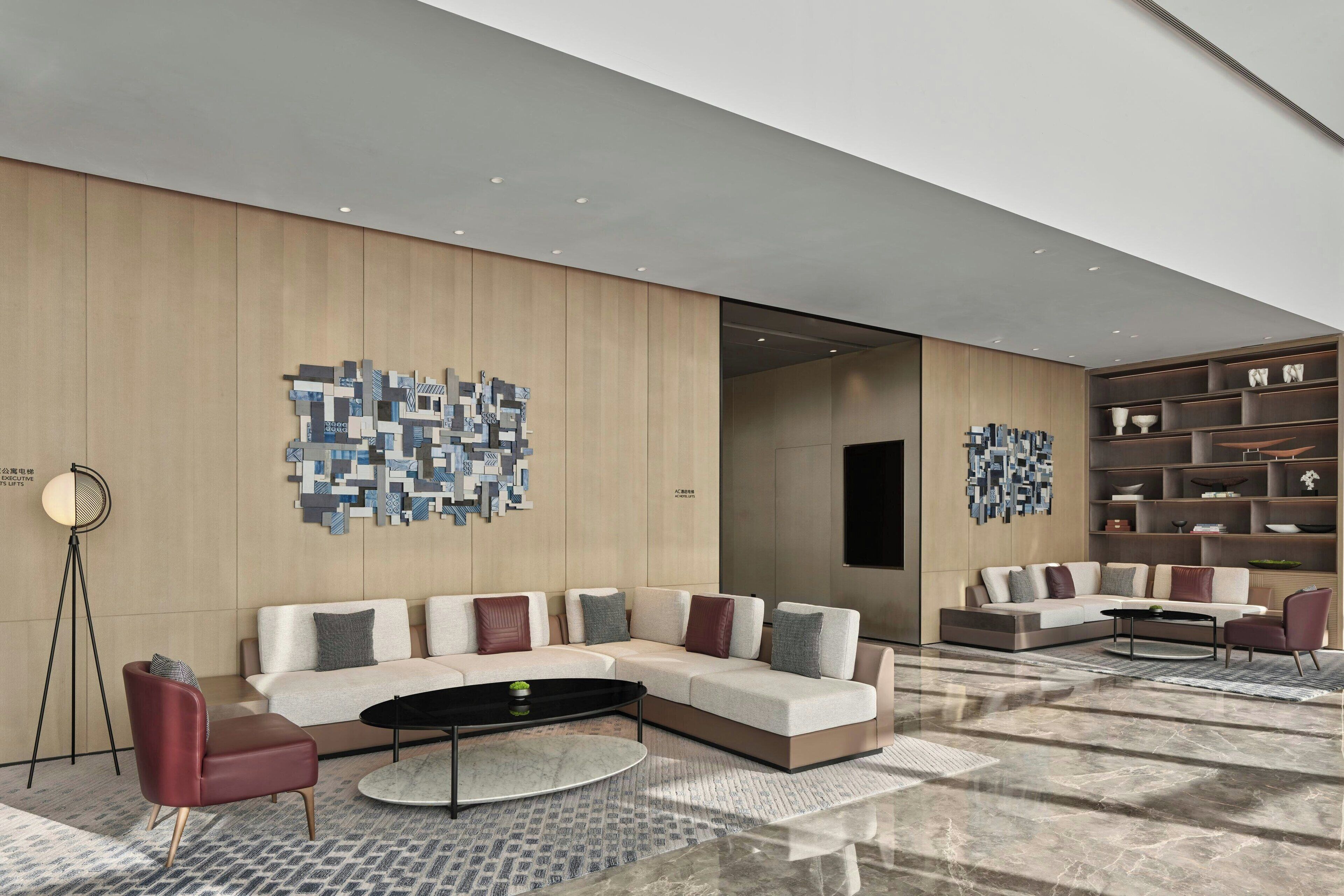 A modern living room with a sectional sofa, a coffee table, and a floor lamp.