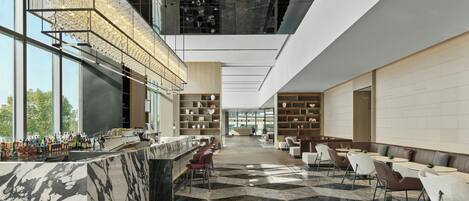 A modern bar area with a marble counter, seating, and a high ceiling with exposed ductwork.