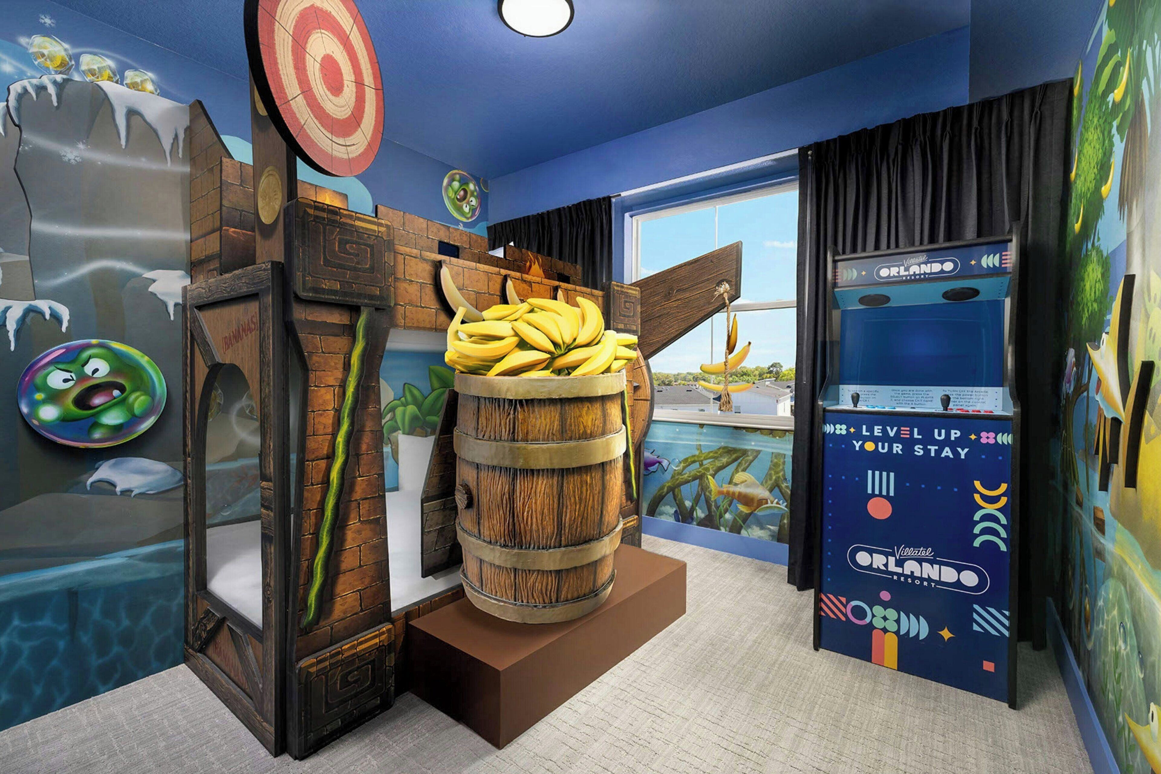 A room with a large barrel, a target on the wall, and a window with curtains.
