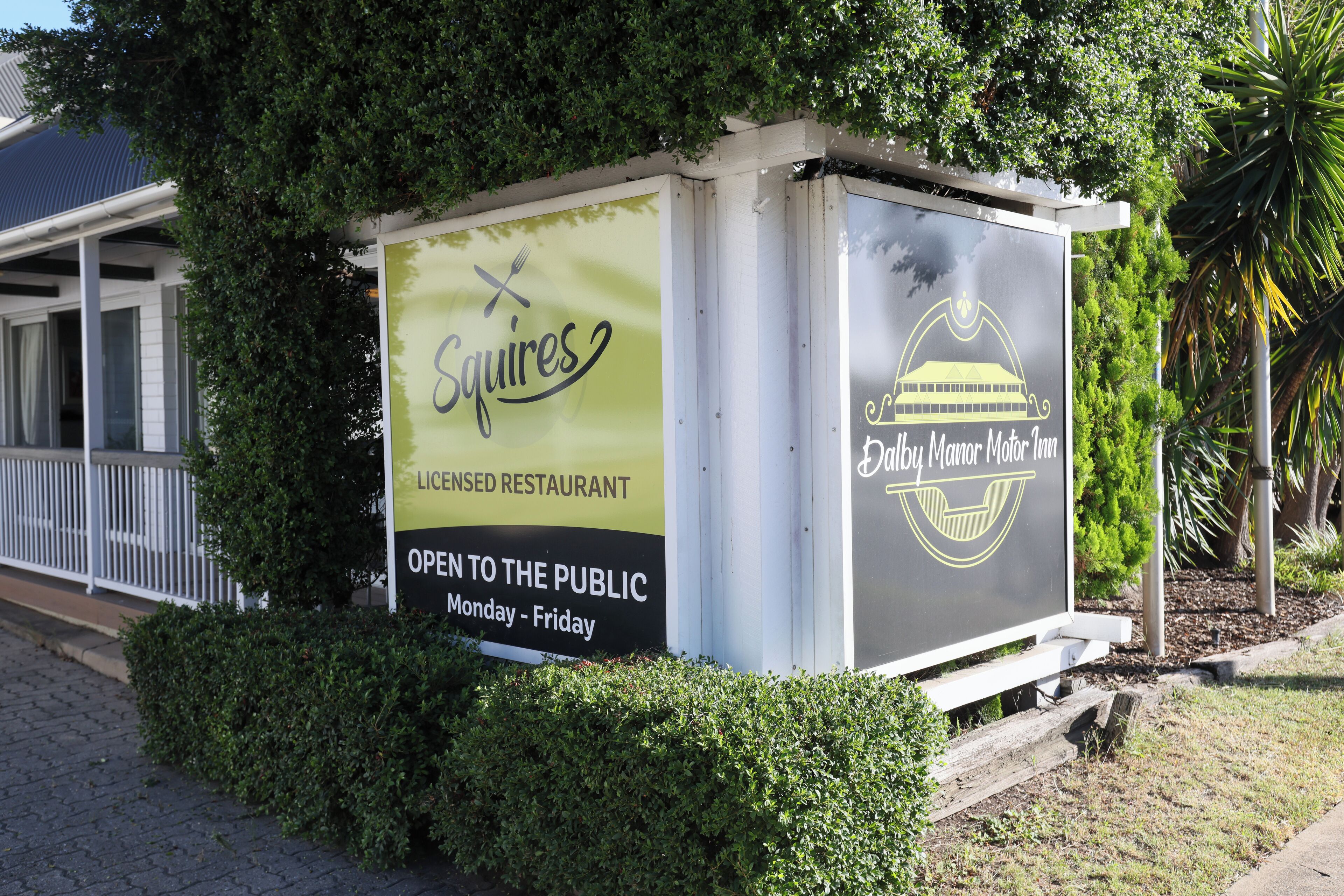 A sign for a licensed restaurant named 'Squires' open to the public from Monday to Friday.