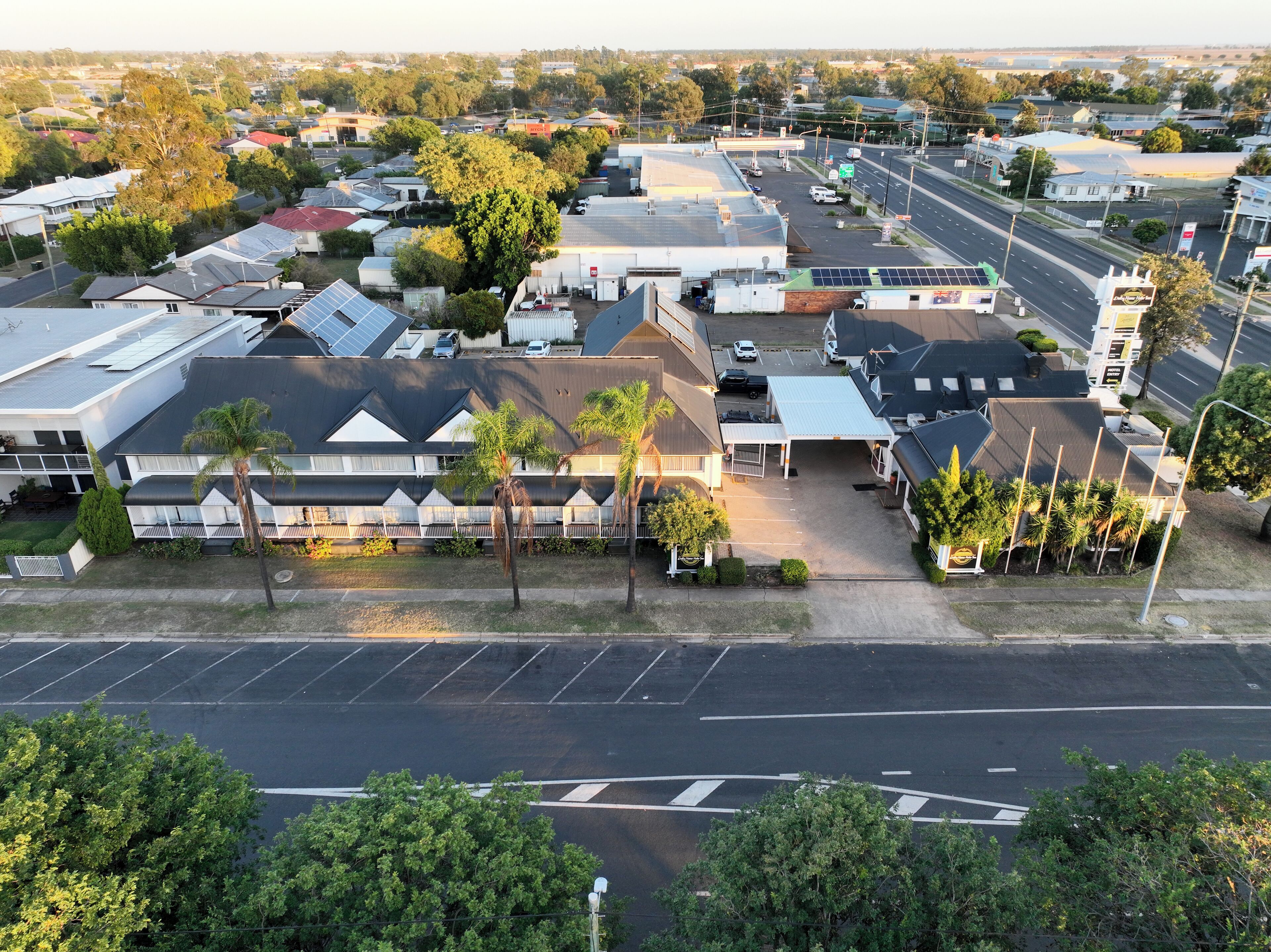 A commercial building with multiple units, a parking lot, and a street view.