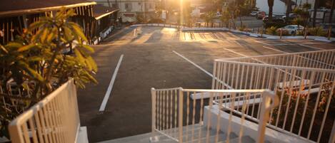 A parking lot with a staircase leading to a building.