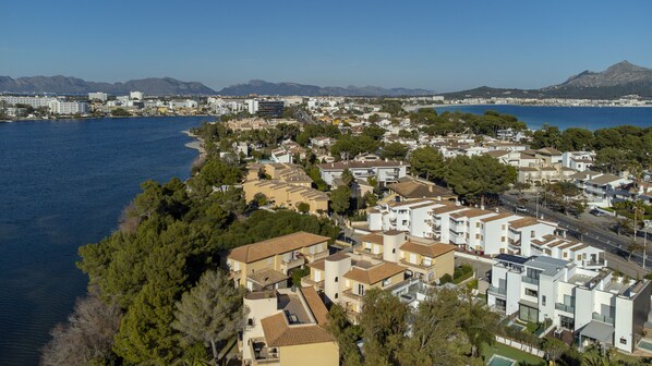 A coastal residential area with a mix of modern and traditional architecture, including a prominent tower building.