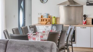 A modern kitchen with a dining area set for six.