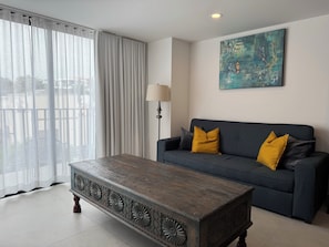 Relax in this stylish living room with a sofa, coffee table, and floor lamp, perfect for unwinding.