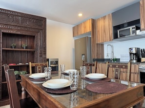 Enjoy cooking and dining in this stylish kitchen with a dining table for four, oven, microwave, and coffee maker.