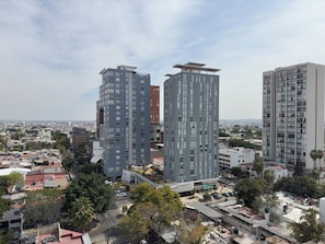 Urban high-rise buildings with a mix of flat and sloped facades.