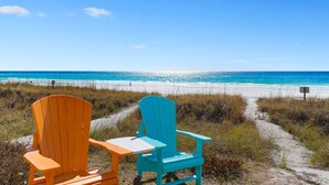 Two Adirondack chairs facing a beach with a clear view of the ocean. - Sea Glass - Huge Ocean Front Home with Gulf Views, Private Pool & Direct Beach Access (Miramar Beach)