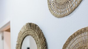 A wall with three woven wall art pieces.