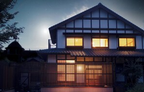 A traditional Japanese house with a tiled roof, wooden walls, and a wooden fence. - Iori Yufuin (Yufu)