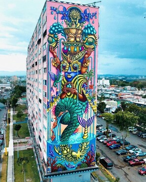A tall building with a colorful mural featuring a mermaid and other sea creatures.