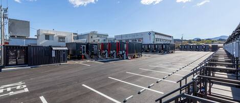 A parking lot with marked spaces and a building in the background.