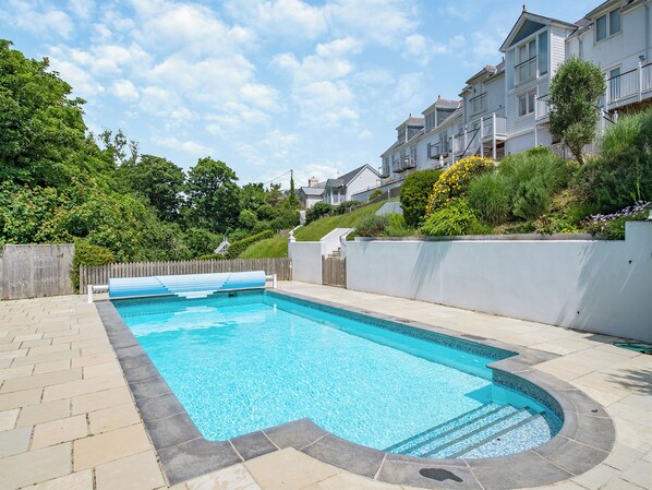 A rectangular swimming pool with a tiled edge, surrounded by a paved deck. - 2 bedroom accommodation in Hallsands (Hallsands)