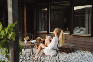Relax in a serene outdoor space with a round table, single chair, and potted plant.
