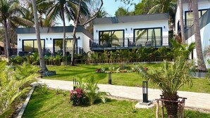 A modern resort with two-story buildings, a well-maintained garden, and a pathway leading to the entrance. - Apsara Resort Koh Rong (Koh Rong)