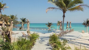 A beach resort with a pool area, lounge chairs, and palm trees. - Apsara Resort Koh Rong (Koh Rong)