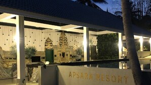 The entrance of Apsara Resort with a sign, palm trees, and a sandy path leading to the building. - Apsara Resort Koh Rong (Koh Rong)