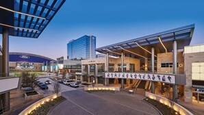 A modern building with a glass facade, a Ford dealership, and a City Works office. - Resort-style, Frisco Getaway, Saltwater Pool, FREE Heated Spa (Frisco)