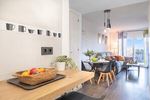 A modern living space with a dining area, a kitchen, and a seating area with a view. - Riviera direct pool access, Mijas Costa, Spain (Mijas Costa)
