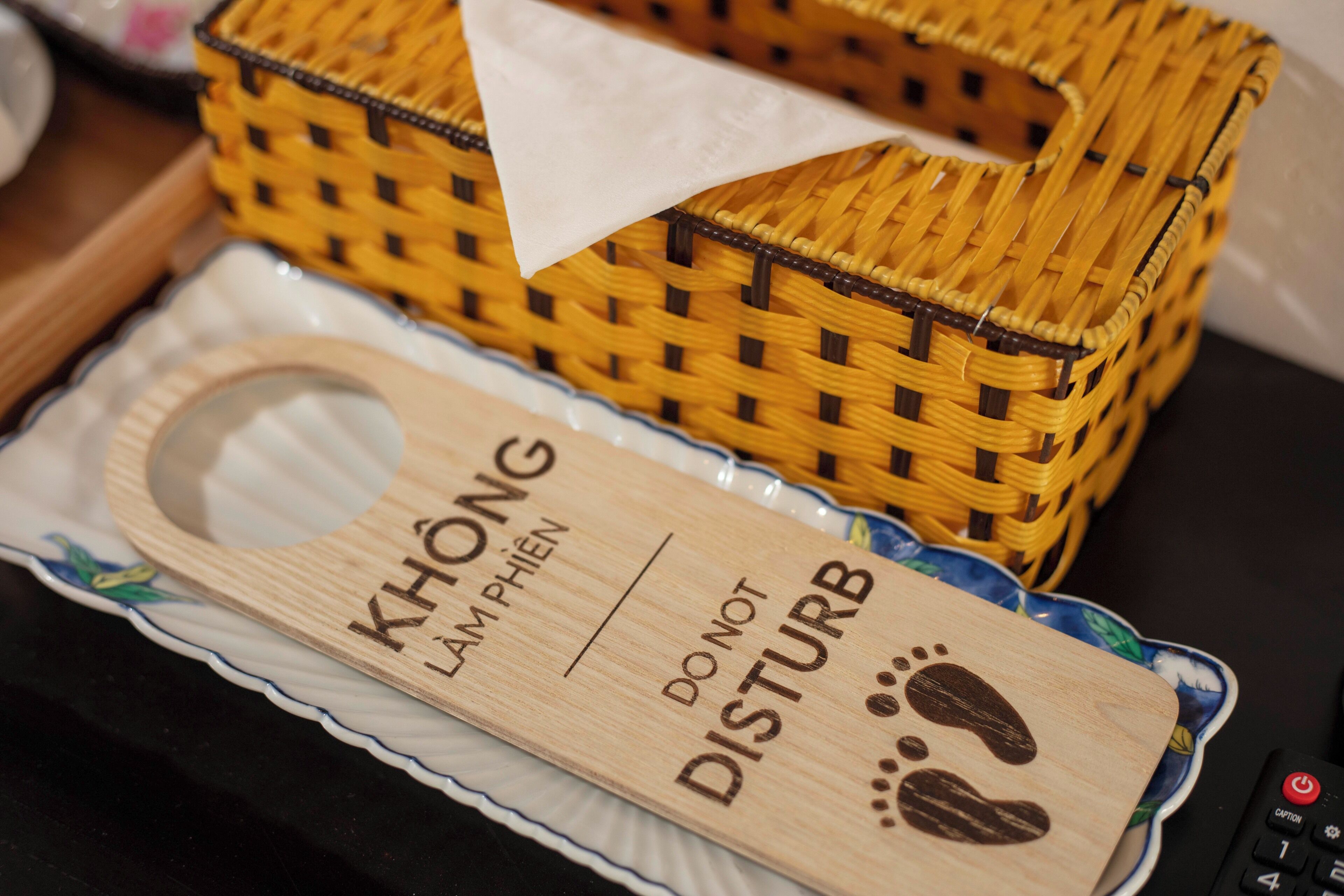 A wooden tray with text and a basket.