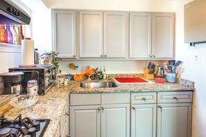 Fridge, microwave, coffee/tea maker, cookware/dishes/utensils