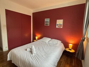 Comfortable retreat with a large bed, two bedside tables, and a spacious wardrobe.
