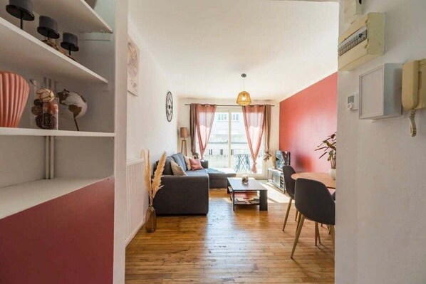 Relax in this inviting living room with a sofa, coffee table, and bookshelf.