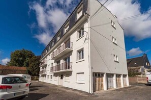 Stylish residential building with balconies on each floor, offering a simple, functional design.