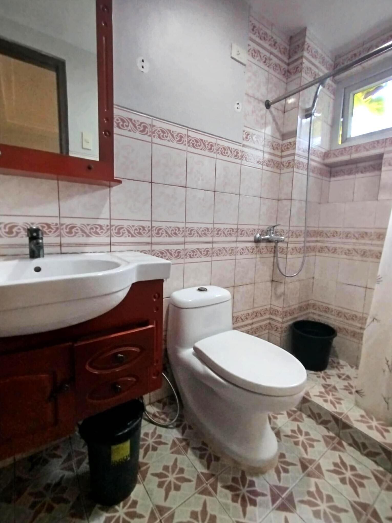 A bathroom with a sink, toilet, and shower.