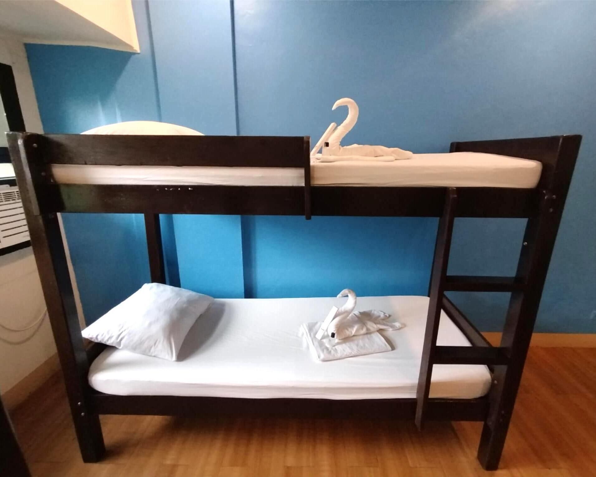 A bunk bed with a swan-shaped pillow on the lower bunk.