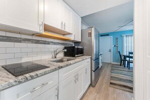 Fridge, microwave, stovetop, coffee/tea maker