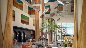 A spacious lobby with high ceilings, wooden accents, and a modern chandelier. - XO Cape Arnna Fethiye (Fethiye)