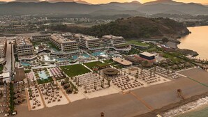 A resort with multiple buildings, a large pool area, and a beach. - XO Cape Arnna Fethiye (Fethiye)