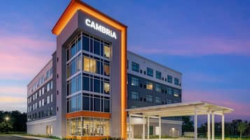 A modern building with a prominent 'CAMBRIA' sign, large windows, and a covered entrance area.