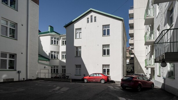 A narrow urban street with white buildings, a red car parked on the side, and a clear blue sky. - Historical Studio & Excellent Location (Tampere)