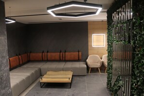 Relax in a stylish seating area with a sofa, armchairs, and a coffee table.