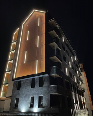 Contemporary building with balconies on each floor, offering outdoor space.