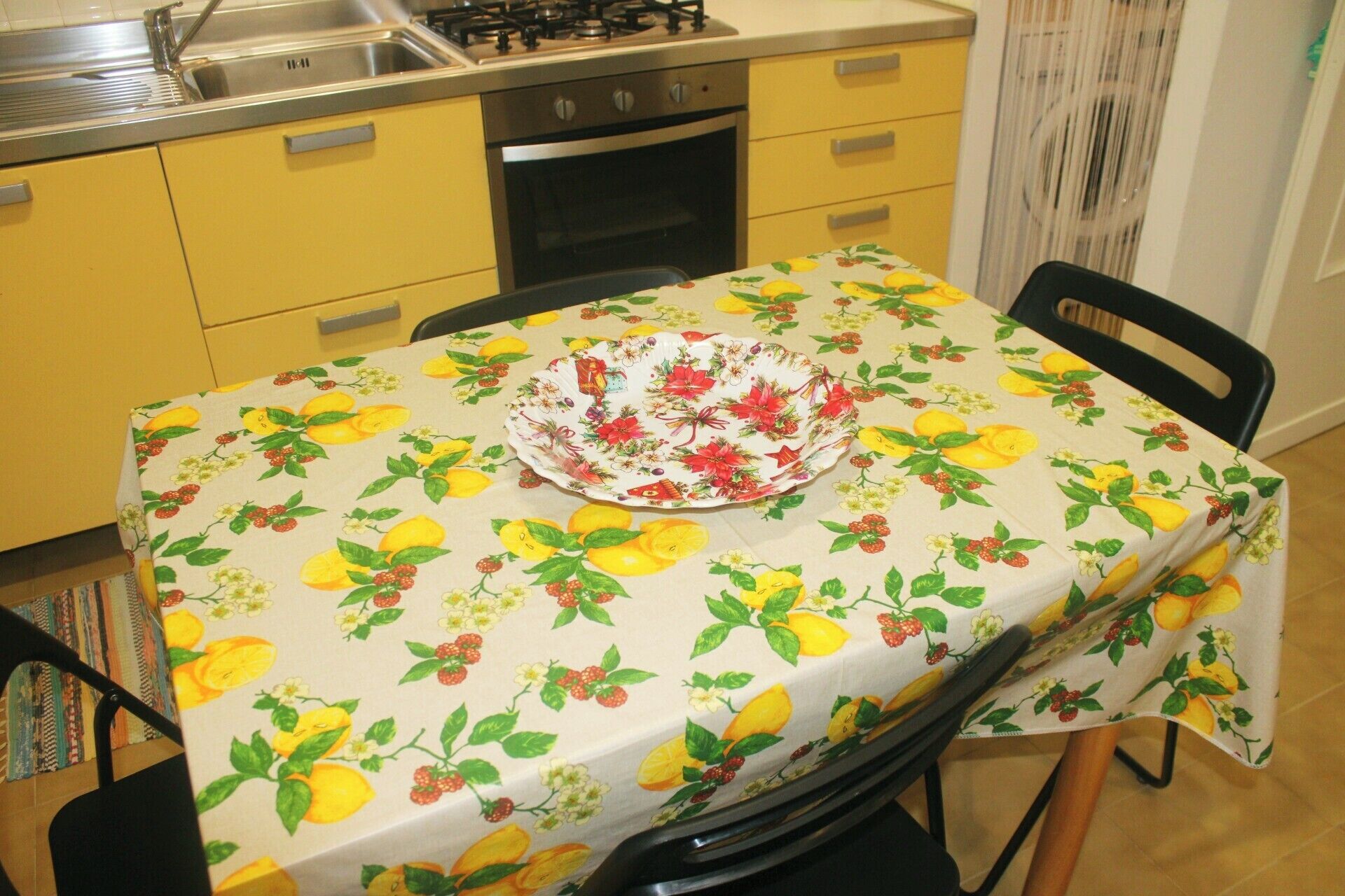 A kitchen with yellow cabinets, a stove, and a sink.