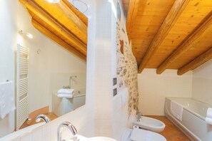 A bathroom with a white sink, a mirror, a bathtub, and a shower. - Antiche Mura by Rent all Como (Como)