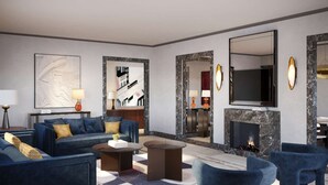 A modern living room with a blue sofa set, a fireplace, and a large mirror. - Palazzo Ottaviani Luxury Apartments (Florence)