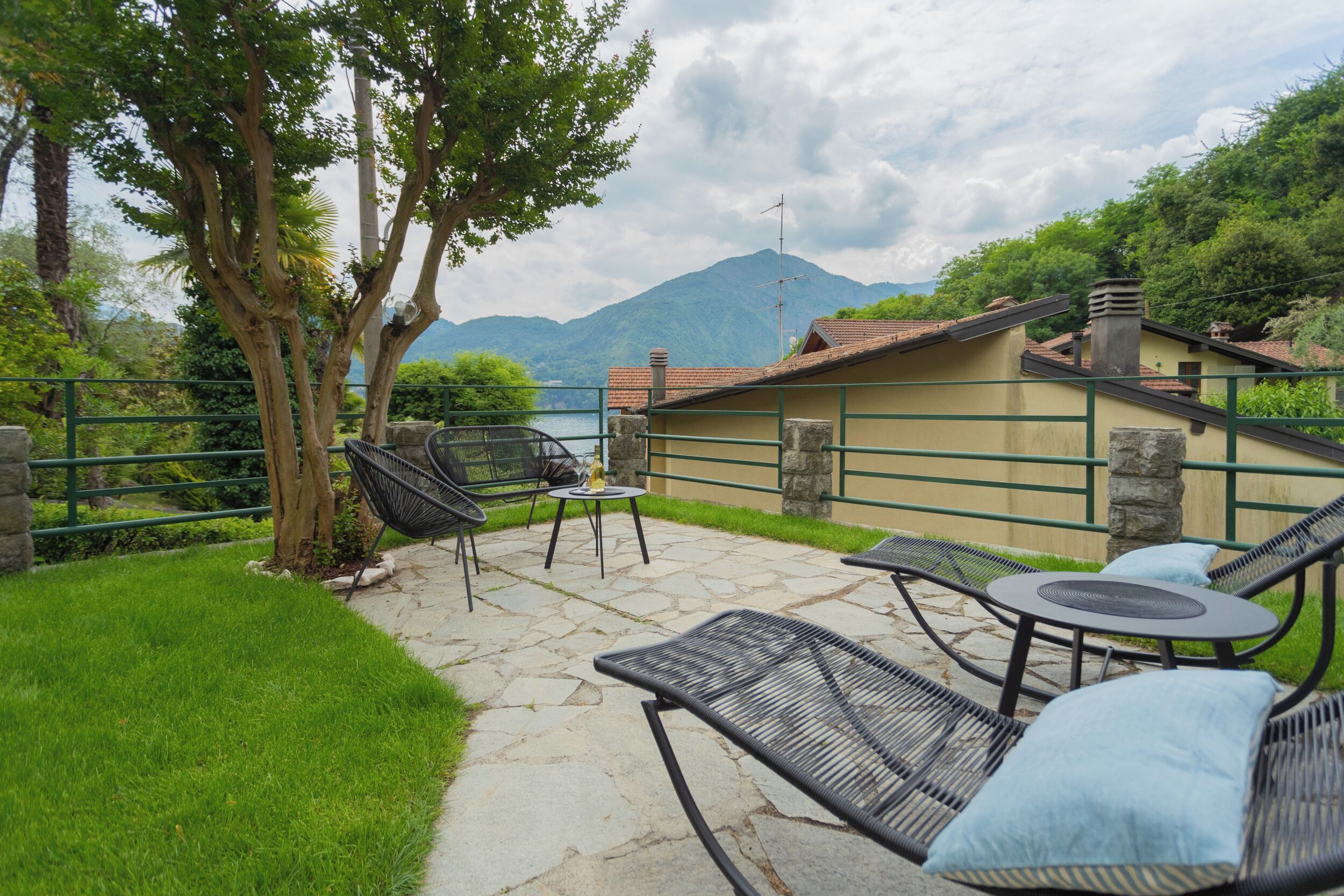 A patio with outdoor furniture, a stone pathway, and a view of mountains.
