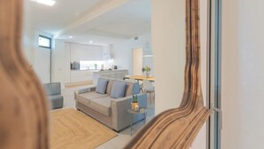 A modern apartment with a living area, kitchen, and dining space. - Salvia & Ginepro Apartments by Rent all Como (Como)