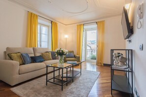 Relax in this stylish living room with a sofa, coffee table, and flat-screen TV.