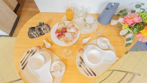 A breakfast setup with a plate of pastries, a pitcher of orange juice, and a coffee pot. - Night at the Museum Apartment by Rent all Como (Como)
