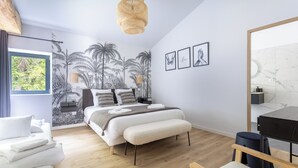A modern bedroom with a bed, bedside tables, a hanging light fixture, and a large window. - Renovated, spacious and comfortable 26-bed mill (Saint-Ignat)