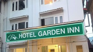 A two-story building with a sign reading "HOTEL GARDEN INN." - Hotel Garden INN (Srinagar)