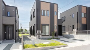 A modern residential building with a flat roof, large windows, and a small garden area. - MOVA Villa Ozu (Ozu)