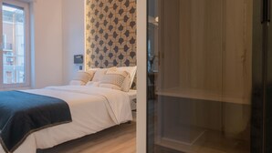 Une chambre à coucher avec un lit, un mur décoré de motifs et une porte coulissante.